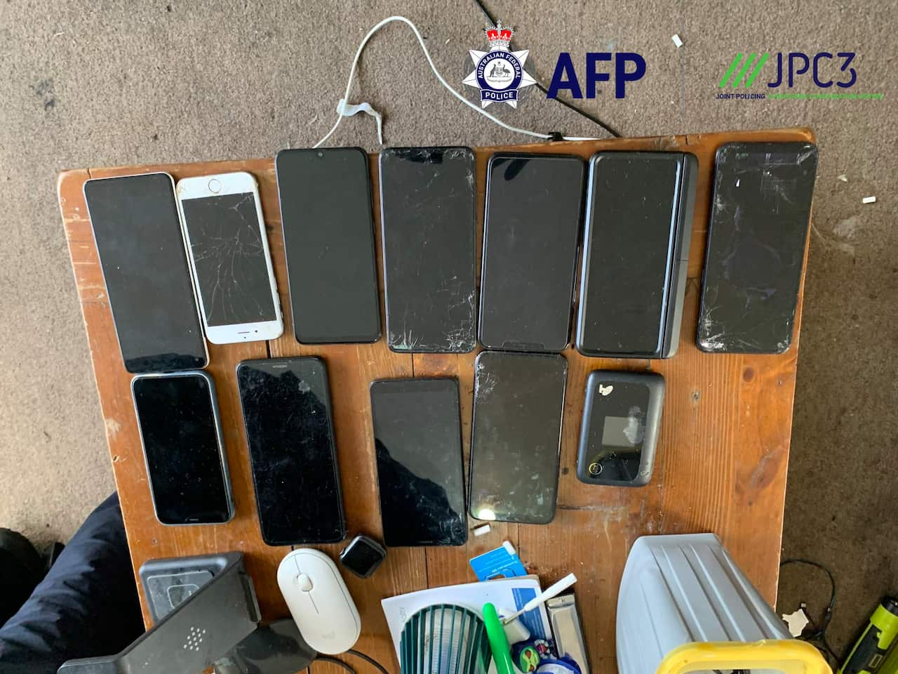 Smartphones are laid out on a table.