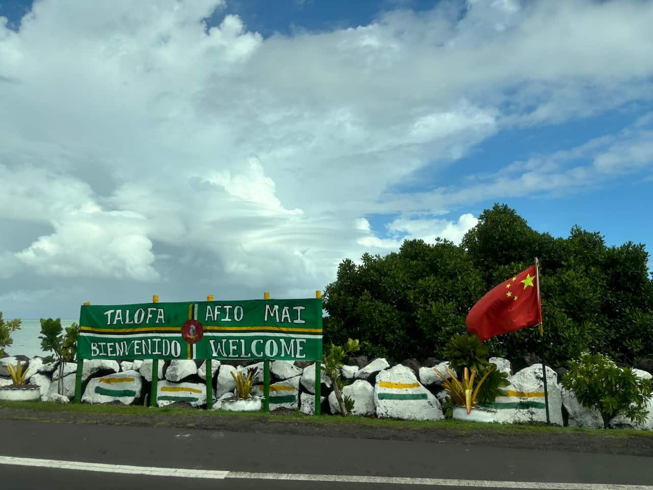 A Chinese flag next to a sign welcoming people to Samoa's capital, Apia.