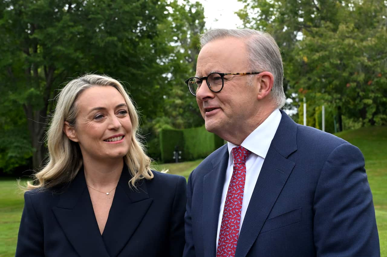 Anthony Albanese's fiancee looks at him and smiles.