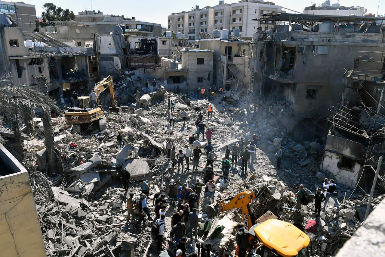 Rescue workers are removing debris from a building devastated by an airstrike.