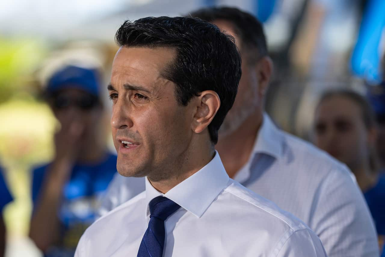 A side profile of a man in a white shirt and a blue tie.