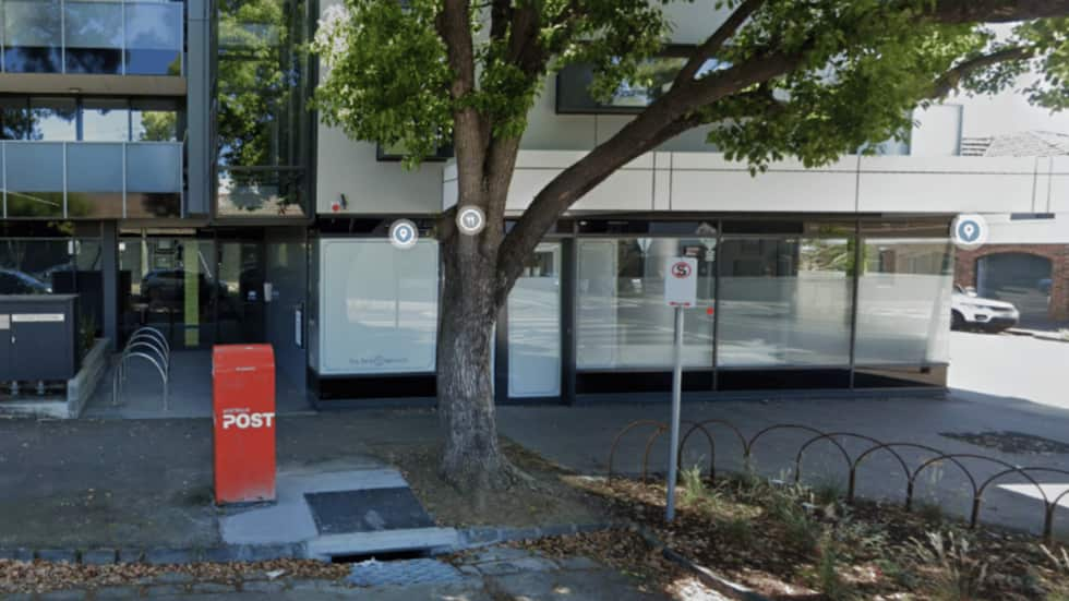 A post box out the front of a building.