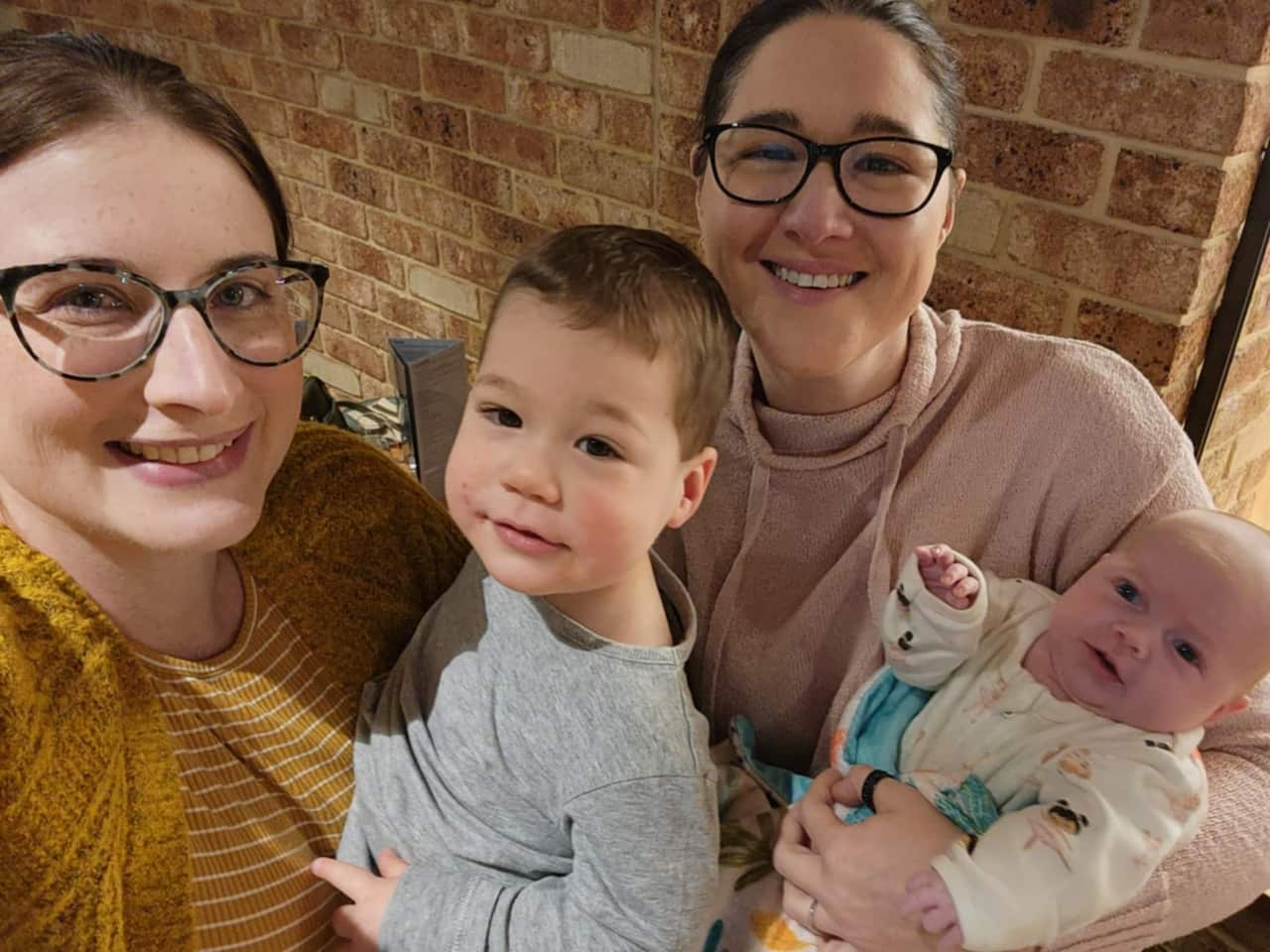 Two women with their two children. 