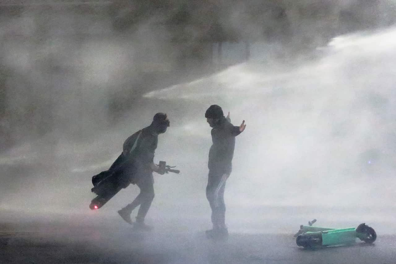 Police use a water cannon on protesters in Tbilisi (AAP)