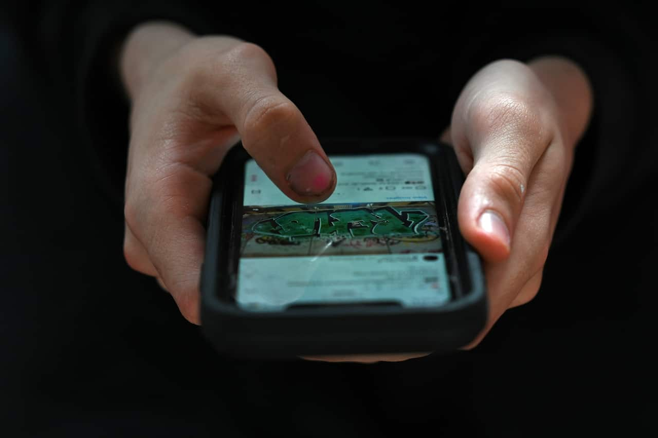 A person holding a phone in their hands.