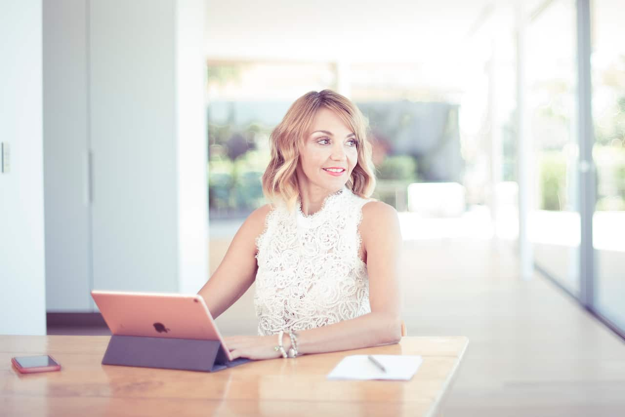  a woman sitting at a laptop computer 