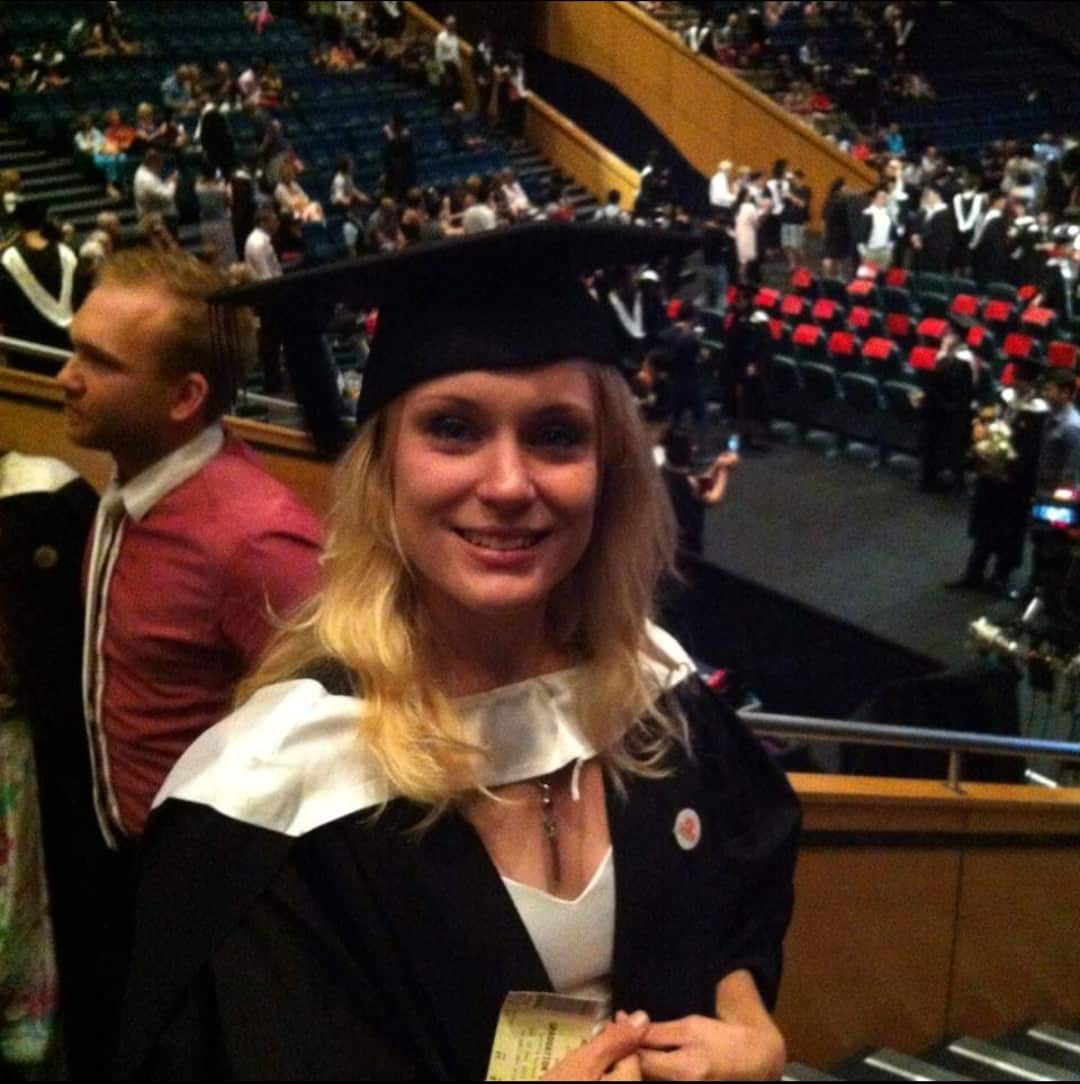 a woman wearing a graduation cap and gown 