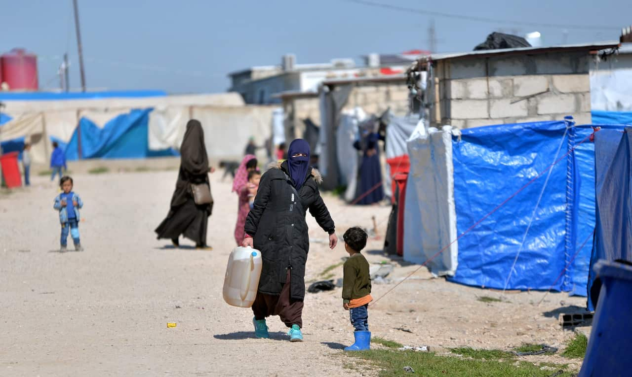 Women and children in a detention camp.