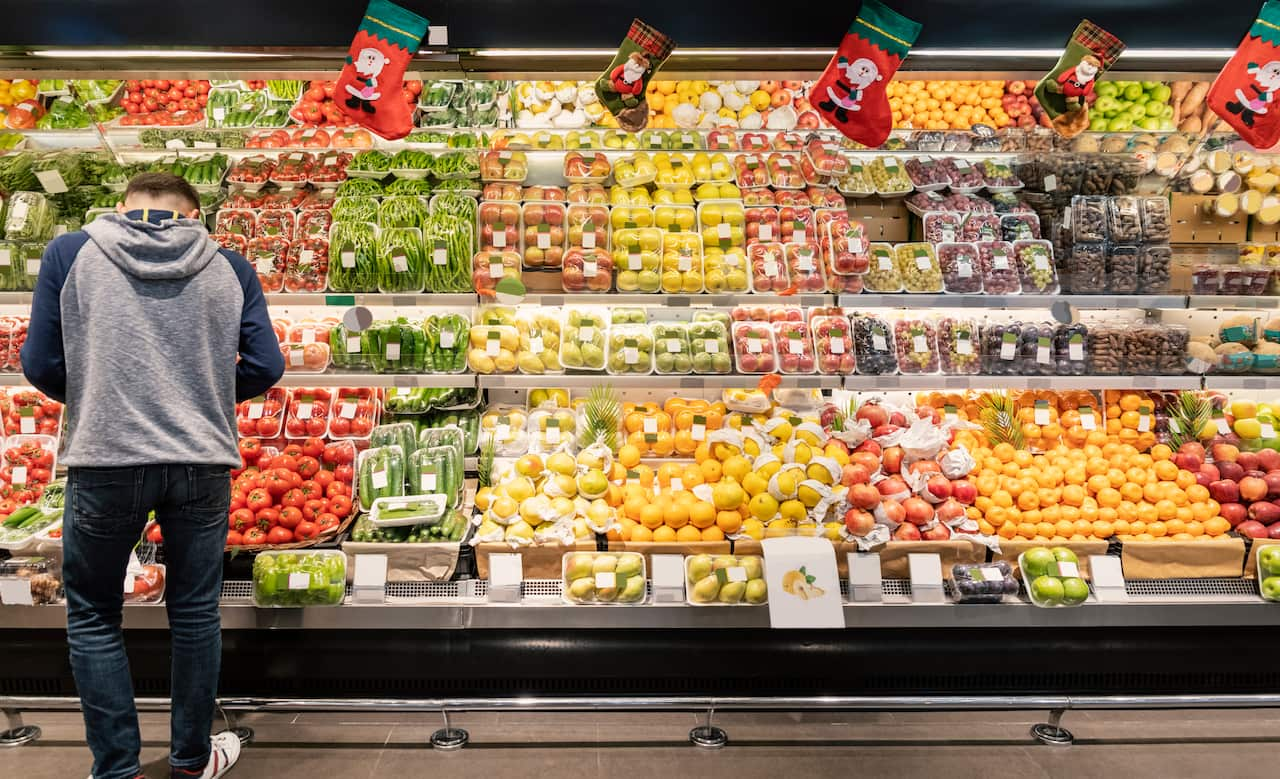 A man looking at vegetables at the supermarket