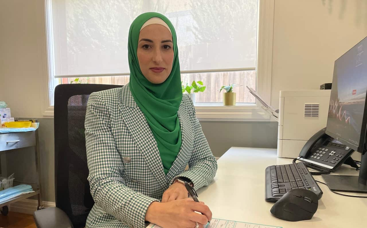 A woman sitting at her desk 