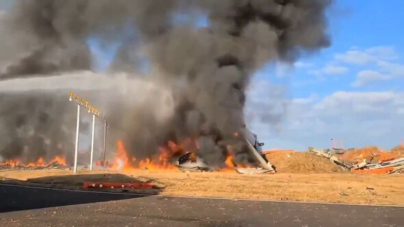 The burning wreckage of a Jeju Air Boeing 737-800 series aircraft is seen 