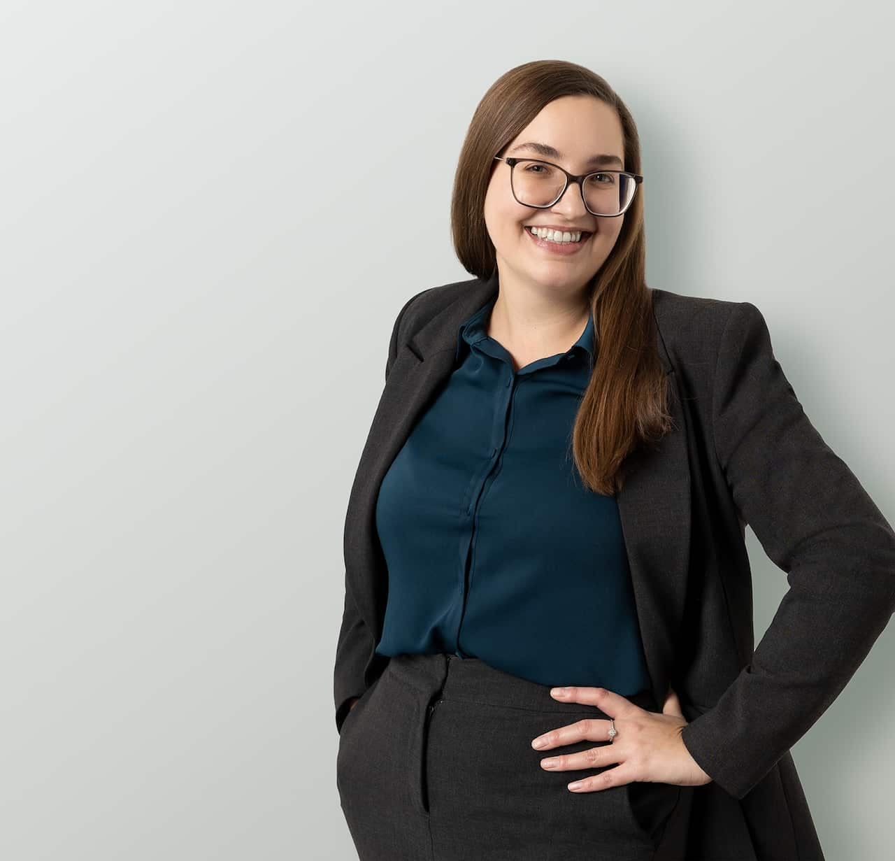 A woman smiling wearing a suit