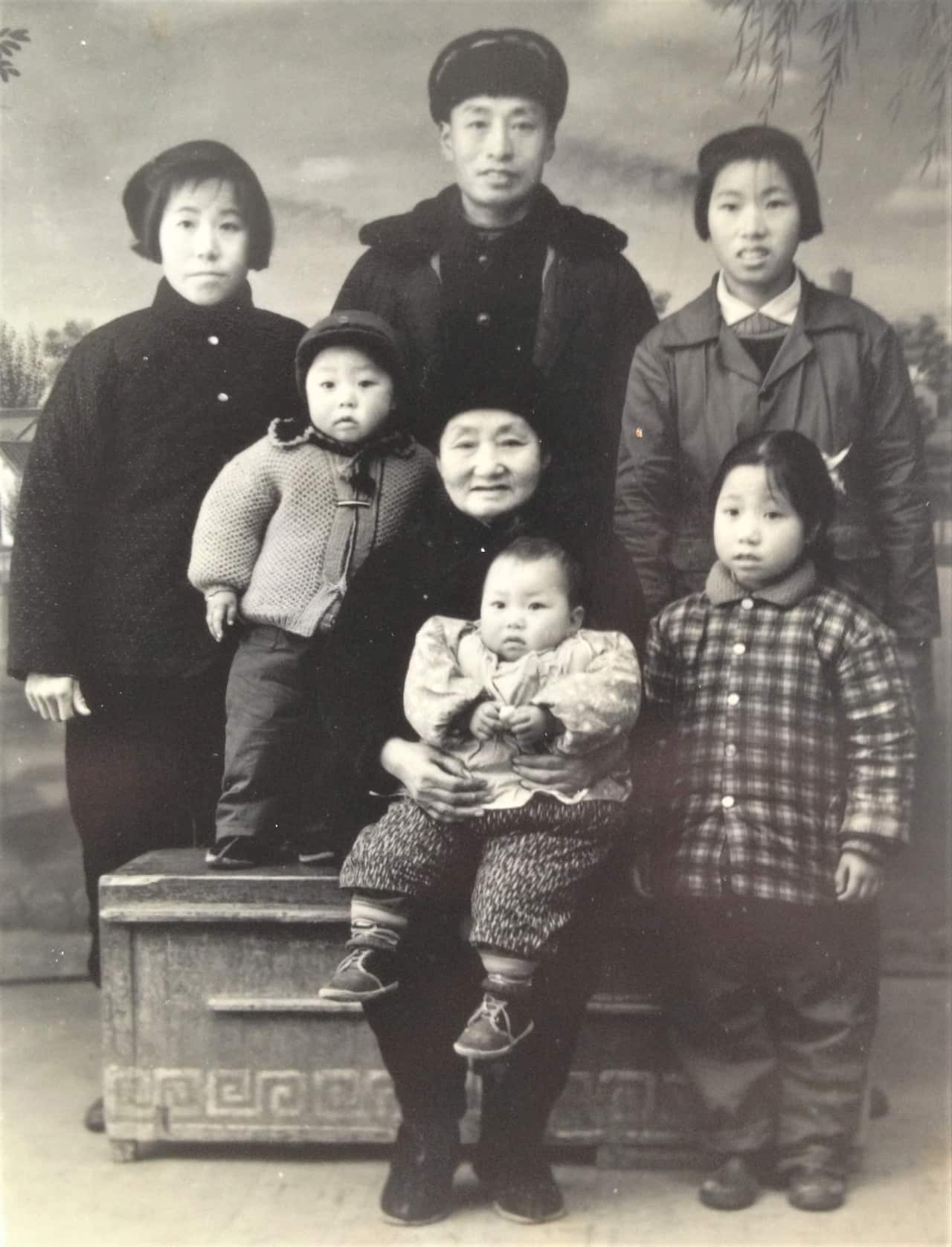 A black and white photo of a family.