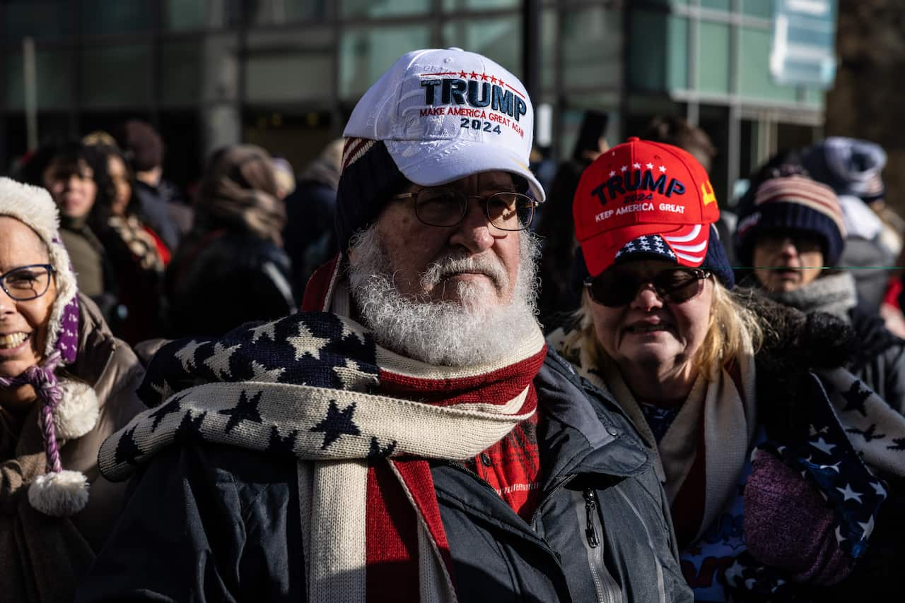 People wearing red, white and blue winter attire and caps.