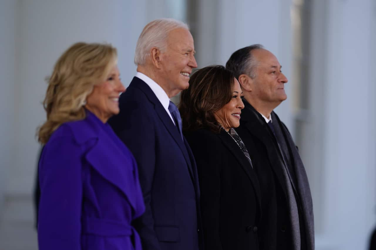 Four people in a line smiling.