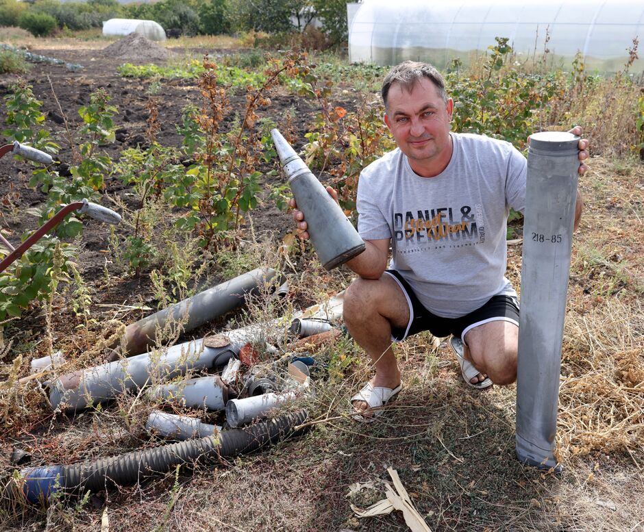 Farmer Ivan holds a missile casing found on his land