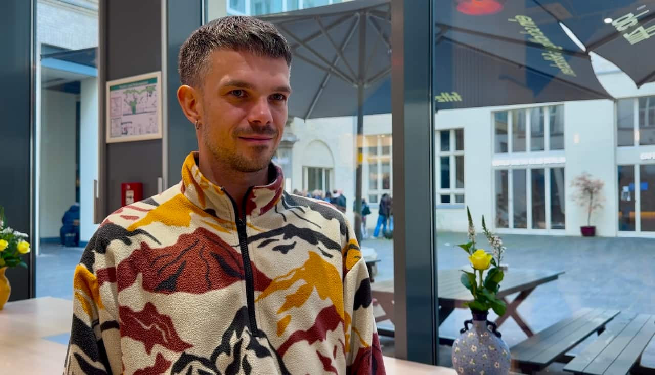 Alexander Sängerlaub is wearing a colourful jumper.