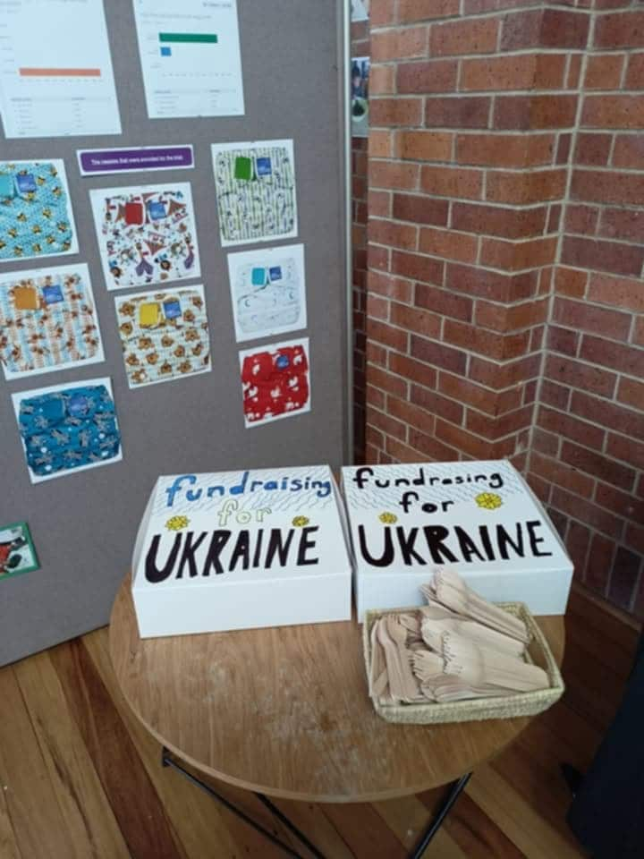 Two boxes of baked goods at a fundraising event, with 'fundraising for Ukraine' seen written on top of the boxes.