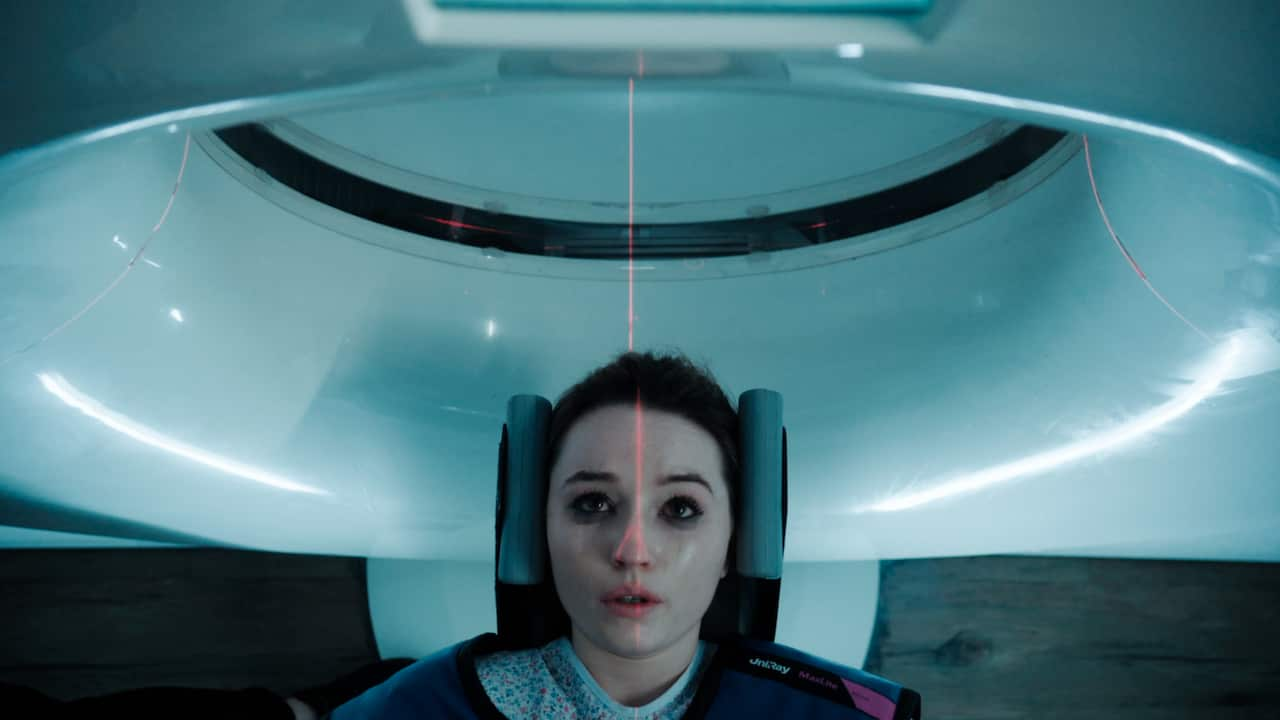 A woman going into an MRI scanner.