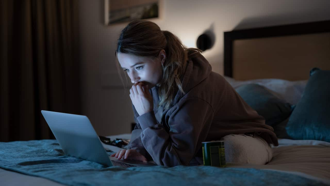 A woman looking at her computer screen.