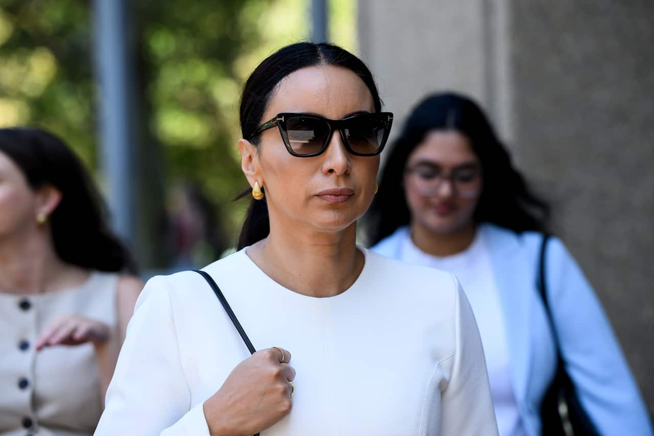 A woman wearing sunglasses outside court. 