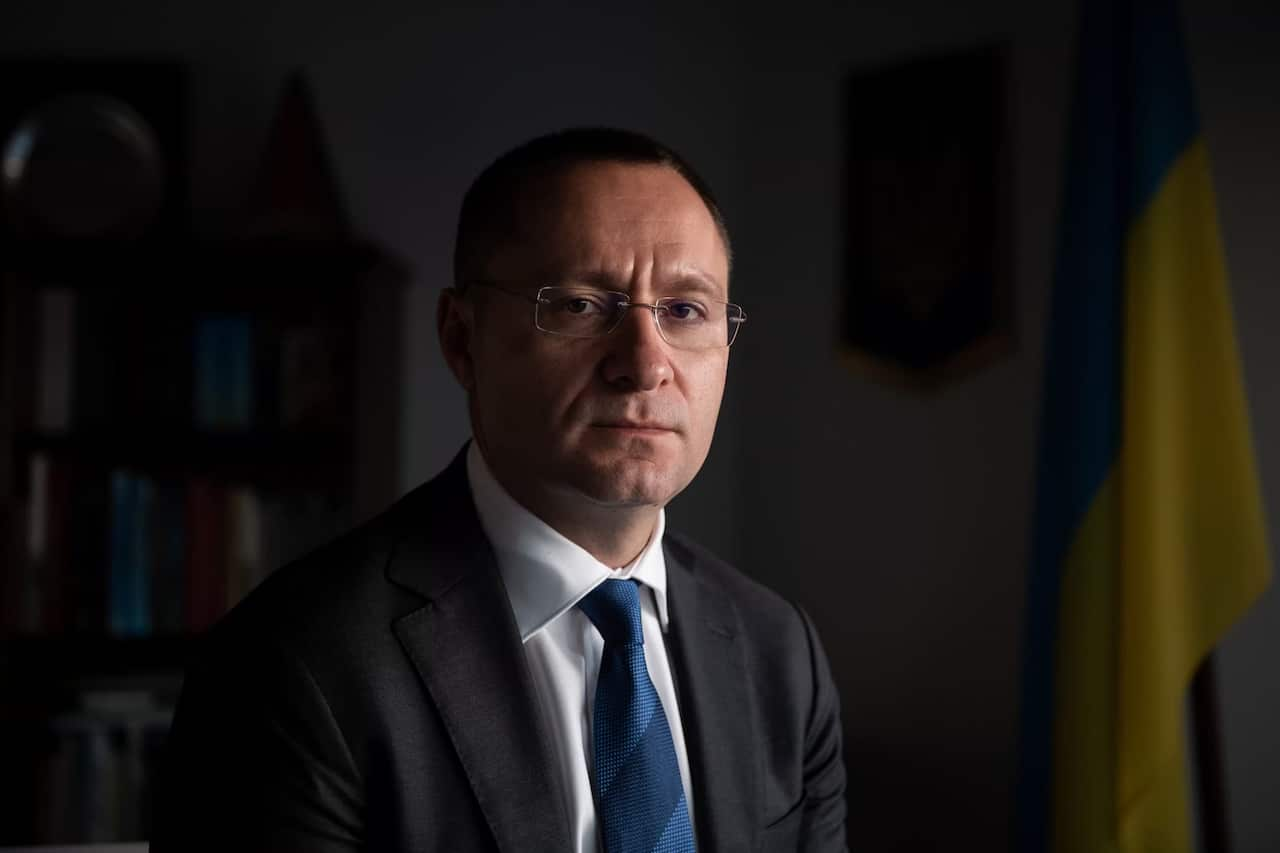 Ukraine's ambassador to Australia, Vasyl Myroshnychenko, wearing a suit.