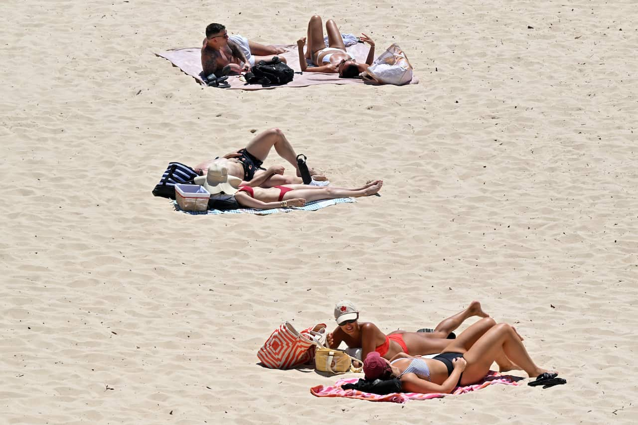 People laying in the sun on a beach